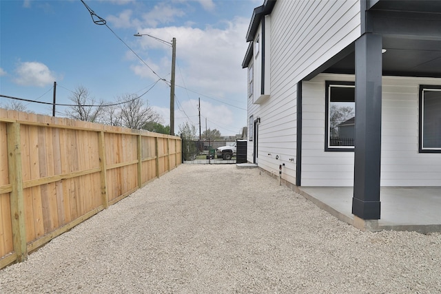 view of side of property with fence and a patio area