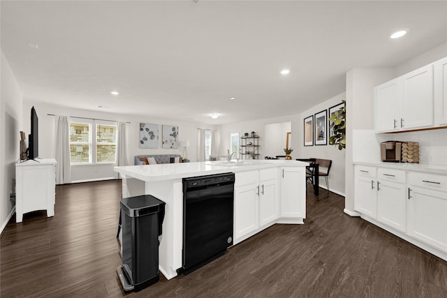 kitchen with tasteful backsplash, light countertops, black dishwasher, and dark wood-style flooring