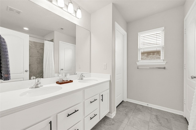 full bath with double vanity, visible vents, baseboards, and a sink