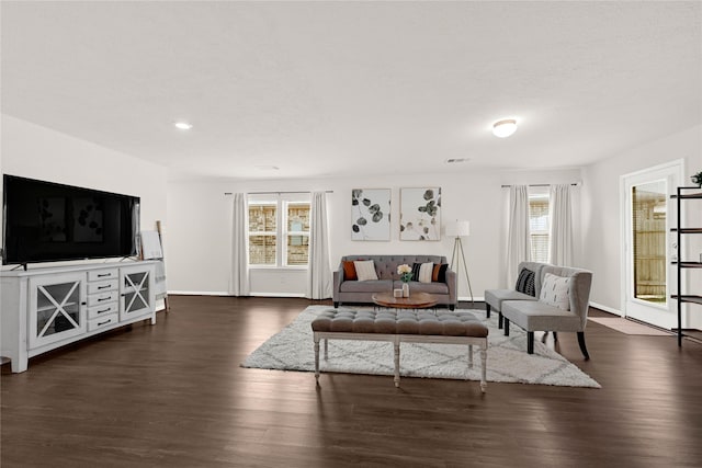 living room with baseboards and dark wood-style floors