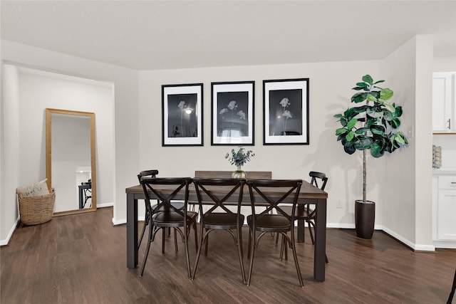 dining room featuring dark wood finished floors and baseboards