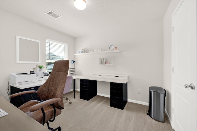 carpeted office featuring visible vents and baseboards