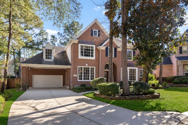 traditional-style home featuring brick siding, fence, concrete driveway, a front yard, and a garage