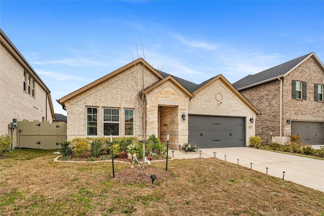 view of front of home with brick siding, fence, concrete driveway, a front yard, and a garage