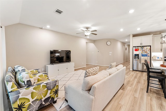 living room featuring visible vents, recessed lighting, light wood-style floors, lofted ceiling, and ceiling fan