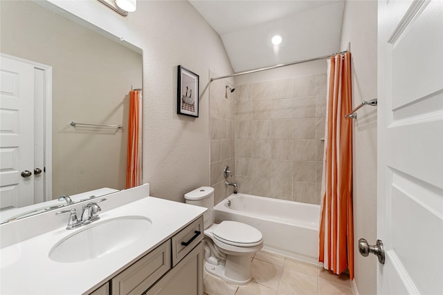 bathroom featuring tile patterned flooring, toilet, lofted ceiling, shower / bath combo, and vanity