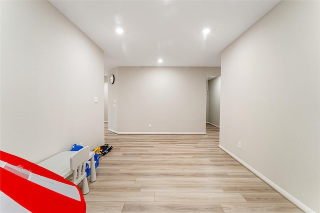 empty room featuring recessed lighting, baseboards, and wood finished floors