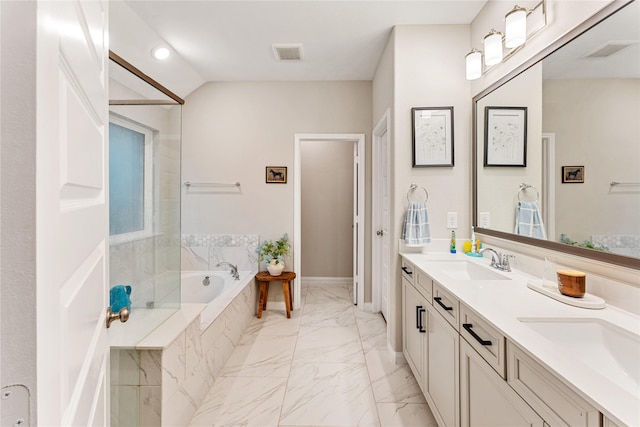 bathroom with visible vents, a garden tub, marble finish floor, a sink, and double vanity