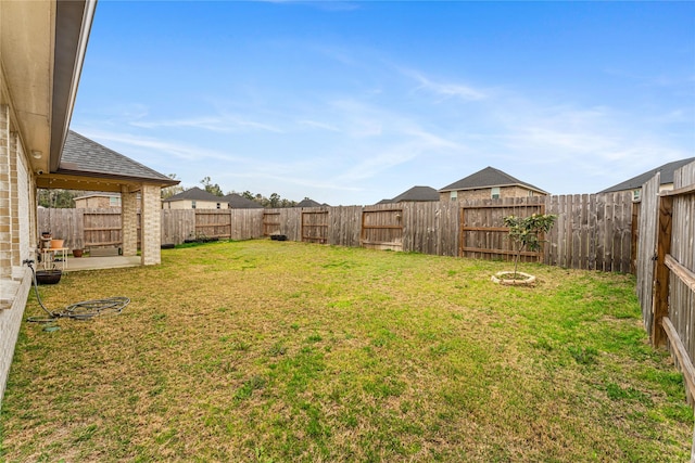 view of yard with a fenced backyard