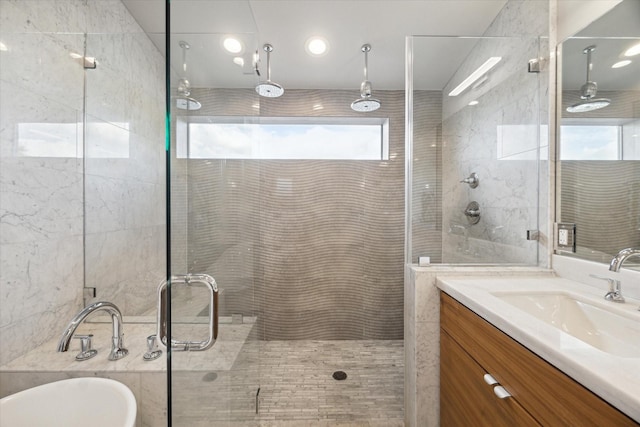 bathroom with a freestanding tub, vanity, and a shower stall