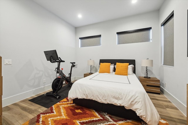 bedroom featuring recessed lighting, baseboards, and wood finished floors