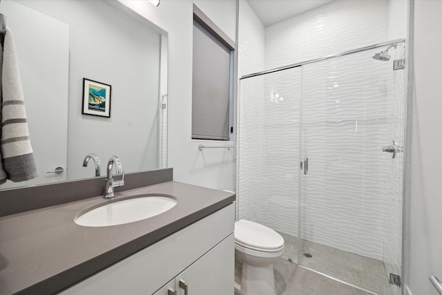 full bathroom featuring a stall shower, toilet, and vanity