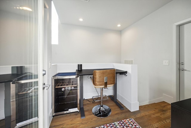 office featuring wood finished floors, recessed lighting, beverage cooler, and visible vents