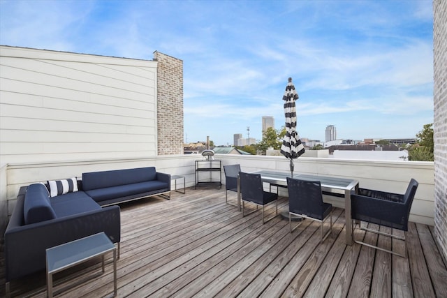 wooden terrace with an outdoor living space and a view of city