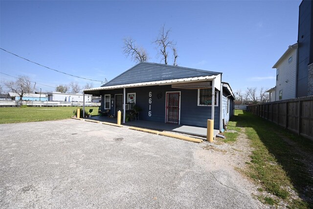 6616 W Montgomery Rd, Houston, TX 77091 - view of front of home featuring fence, metal roof, and a porch