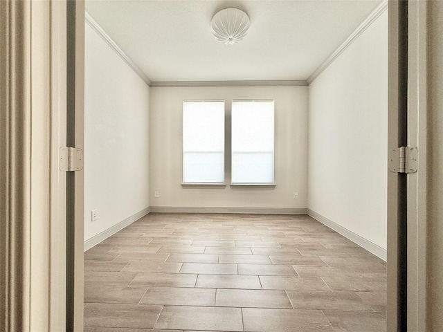 spare room with ornamental molding, baseboards, and wood finish floors