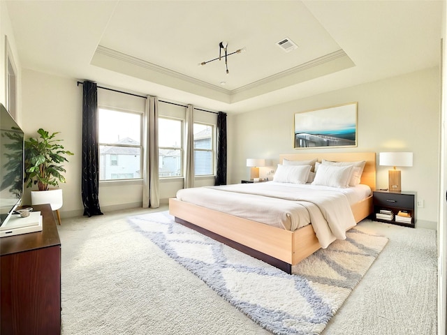 bedroom with a raised ceiling, crown molding, light colored carpet, and visible vents