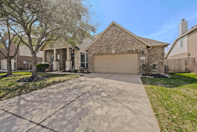 view of front of property with brick siding, a front lawn, fence, concrete driveway, and an attached garage