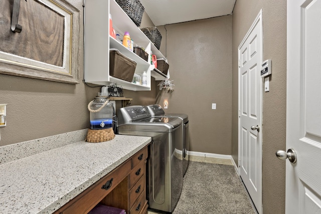 laundry area with baseboards, washing machine and dryer, laundry area, and a textured wall