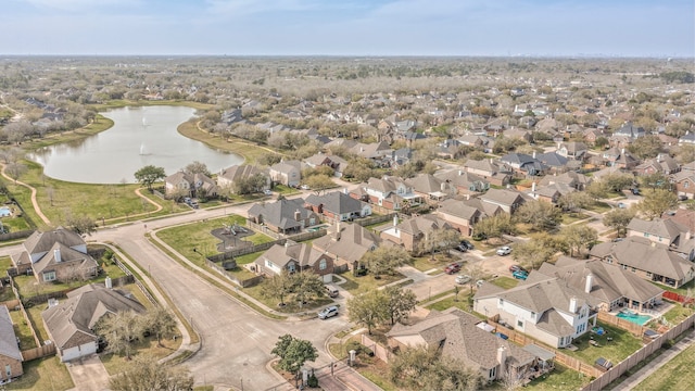 drone / aerial view featuring a water view and a residential view