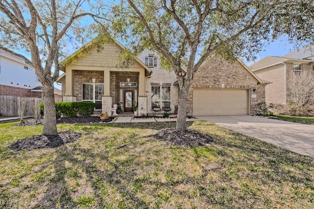 view of front of home featuring a garage, stone siding, driveway, and fence