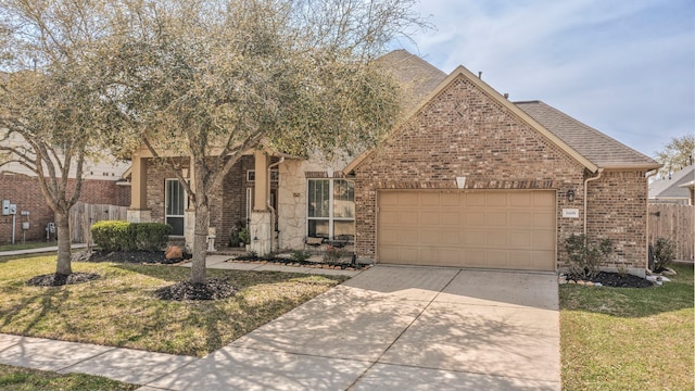 view of front of property featuring driveway, fence, roof with shingles, an attached garage, and brick siding