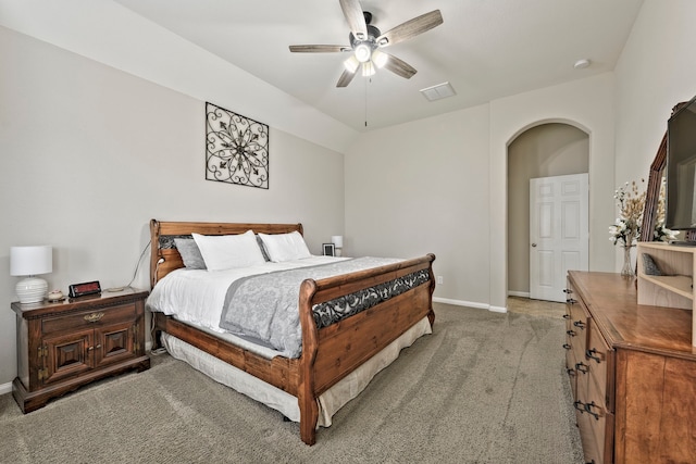 bedroom with visible vents, baseboards, ceiling fan, light colored carpet, and arched walkways