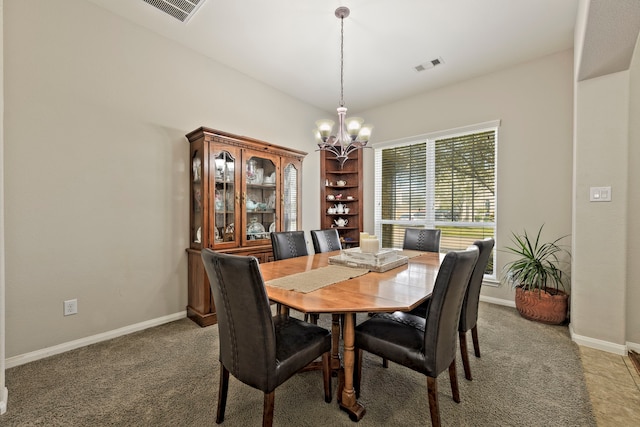 dining space featuring a chandelier, visible vents, light colored carpet, and baseboards