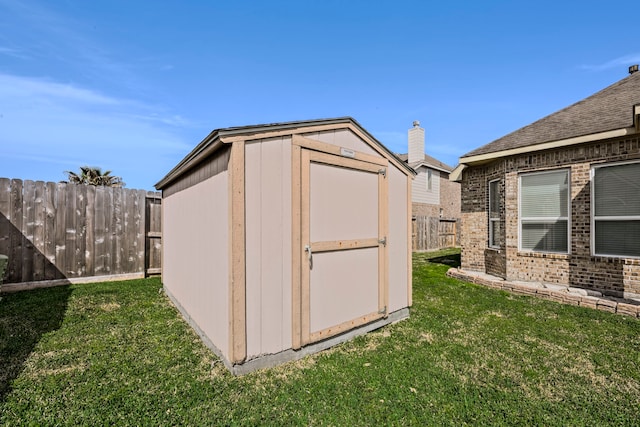 view of shed featuring fence