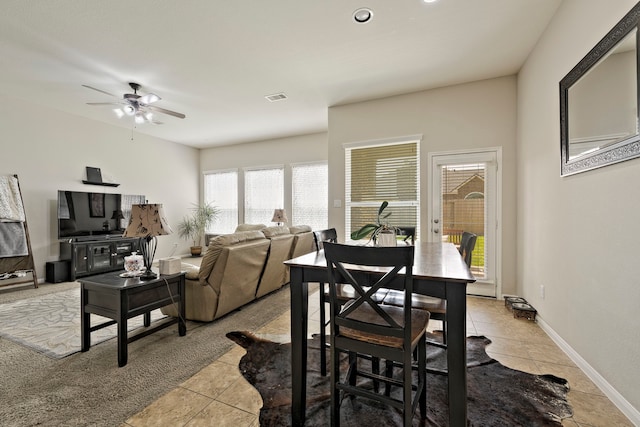 dining area with light tile patterned floors, visible vents, baseboards, and ceiling fan