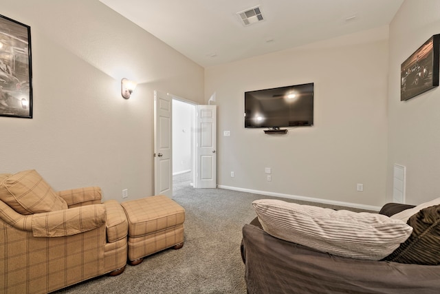 living room with visible vents, baseboards, and carpet