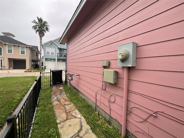 view of property exterior with a lawn and fence