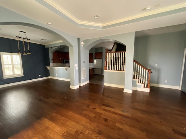 unfurnished living room with crown molding, baseboards, and dark wood-style flooring