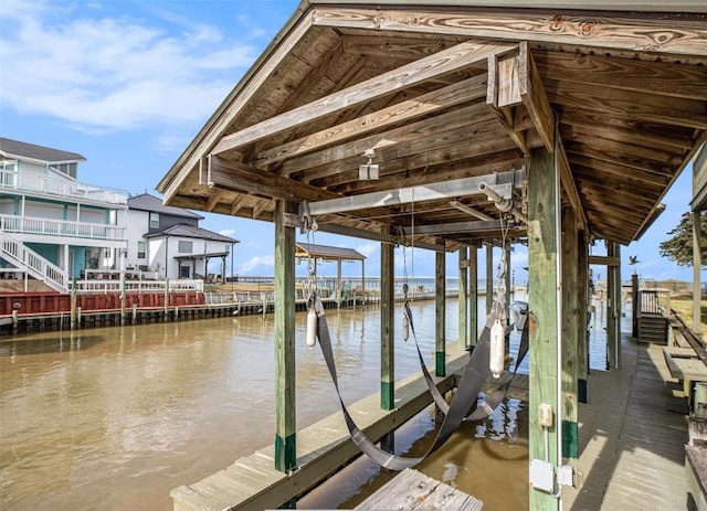 dock area with a water view and boat lift