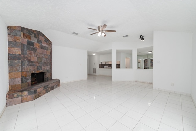 16123 Ridgegreen Dr, Houston, TX 77082 - unfurnished living room with a stone fireplace, lofted ceiling, a ceiling fan, and visible vents