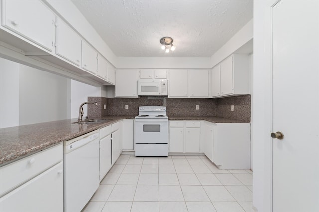 16123 Ridgegreen Dr, Houston, TX 77082 - kitchen with white appliances, light tile patterned flooring, a sink, white cabinetry, and tasteful backsplash