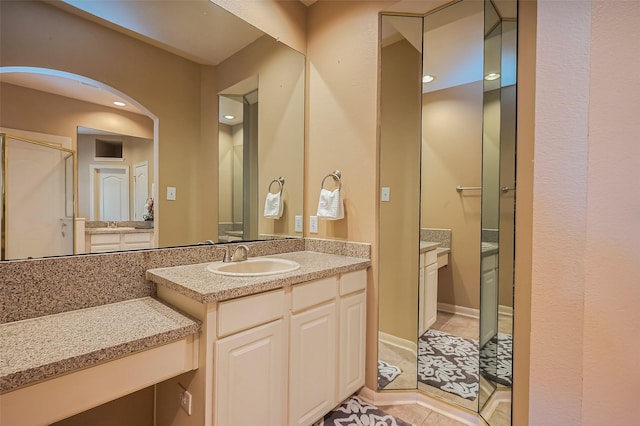full bathroom with tile patterned flooring, vanity, a shower with door, and recessed lighting