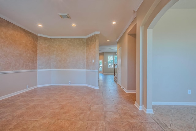 spare room featuring crown molding, recessed lighting, arched walkways, and baseboards