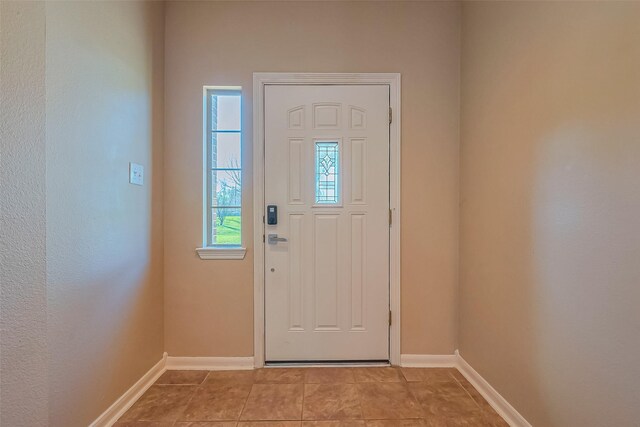 entrance foyer with baseboards and light tile patterned floors