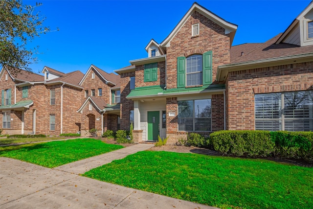 view of front of house with brick siding and a front yard