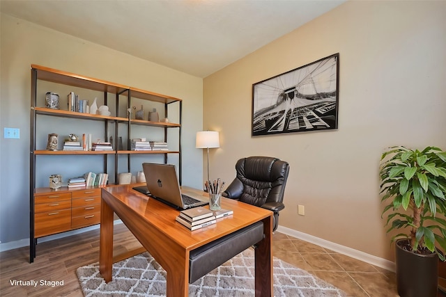 office space featuring baseboards and tile patterned floors