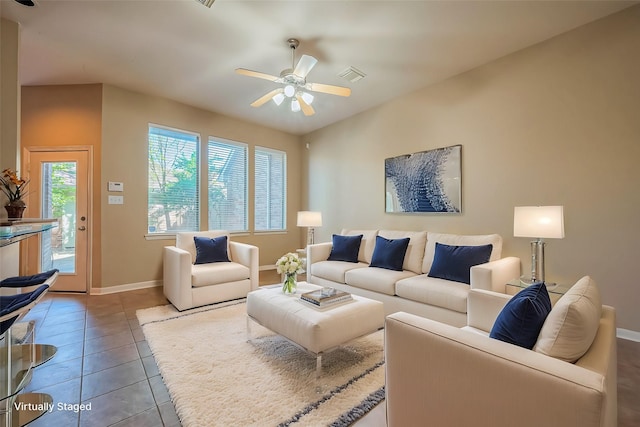 living room with a ceiling fan, baseboards, and tile patterned floors