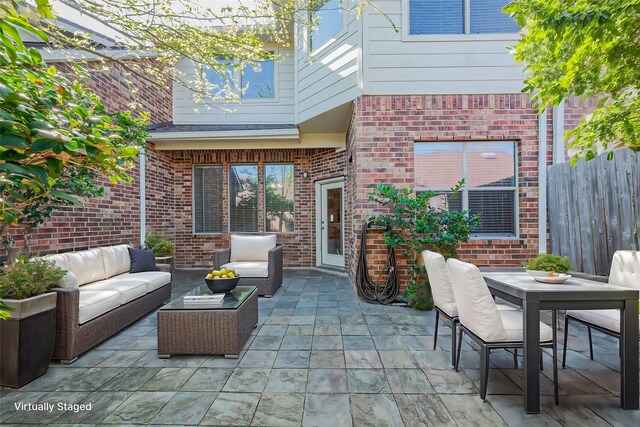 view of patio featuring an outdoor hangout area, fence, and outdoor dining area