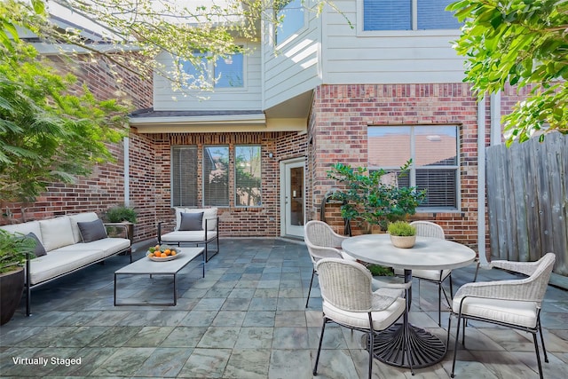 view of patio / terrace featuring an outdoor hangout area and fence