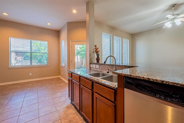 kitchen featuring dishwasher, a sink, healthy amount of natural light, light tile patterned floors, and recessed lighting