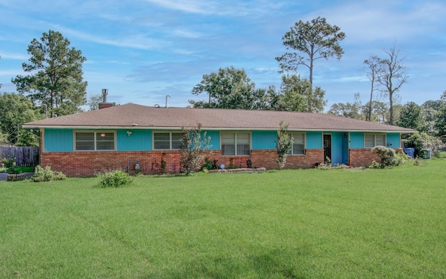 ranch-style home featuring a front yard and brick siding