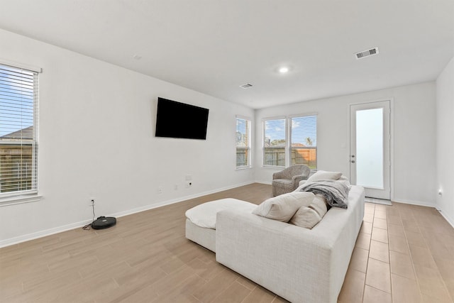 living room featuring recessed lighting, visible vents, baseboards, and light wood-style floors