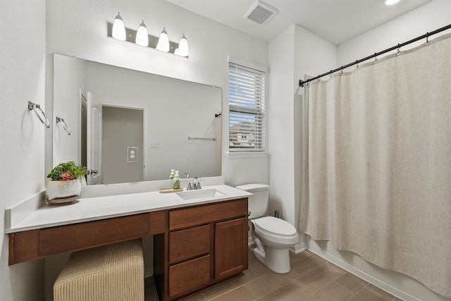 bathroom with vanity, visible vents, tile patterned floors, toilet, and shower / tub combo with curtain