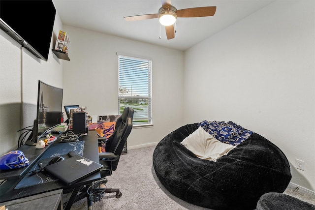 home office featuring baseboards, carpet floors, and a ceiling fan