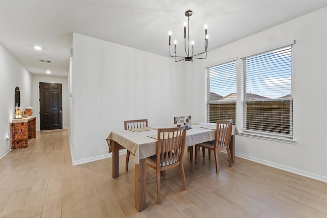 dining room with visible vents, baseboards, recessed lighting, light wood-style floors, and an inviting chandelier